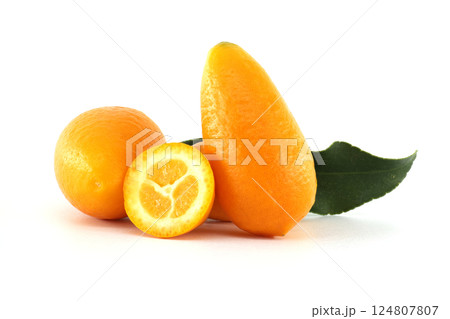 Fresh kumquats with leaf and a half fruit showing the pulp 124807807