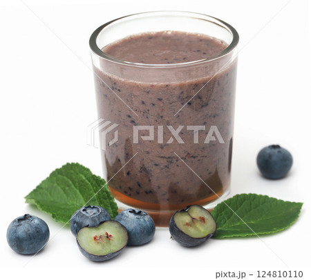 Fresh blueberries and juice in a glass 124810110