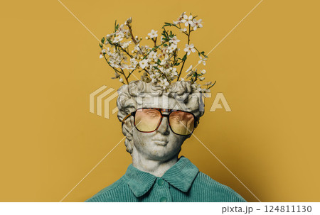 Classical white bust with a blooming tree branch sprouting from his head. Classical white bust with a blooming tree branch sprouting from his head. 124811130