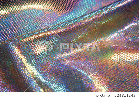 Colorful reflections on a metallic surface create an ethereal atmosphere in a dimly lit space 124811245