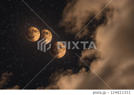 Three full moons shining brightly in a starry night sky 124811351