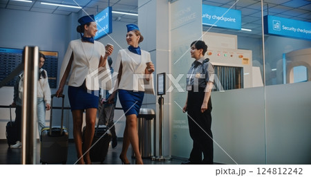Crowded Airport Terminal: Airline Captain and Two Stewardesses Passing Security Checkpoint Crowded Airport Terminal: Airline Captain and Two Stewardesses Passing Security Checkpoint 124812242