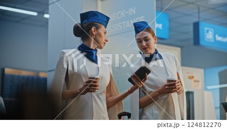 Woman Coming to Flight Attendants in Airport Terminal, Taking Selfie Using Phone 124812270