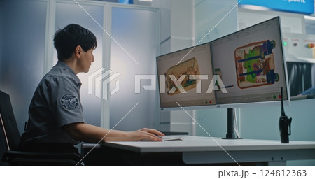 Airport Security Checkpoint: Female Security Officer Monitoring X-ray Scanning of Luggage on Computer Screens 124812363