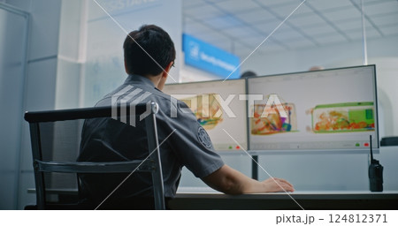 Female TSA Worker Controlling X-ray Scanning of Baggage. Diverse Passengers During Screening Procedure Female TSA Worker Controlling X-ray Scanning of Baggage. Diverse Passengers During Screening Procedure 124812371