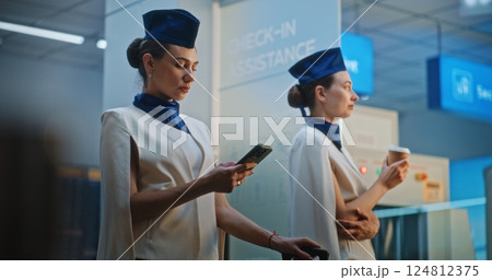 Two Beautiful Flight Attendants Talking, Waiting for Commercial Flight Two Beautiful Flight Attendants Talking, Waiting for Commercial Flight 124812375