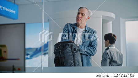 Diverse Passengers During Security Check with Hand Luggage. Program with Scanning of Baggage Diverse Passengers During Security Check with Hand Luggage. Program with Scanning of Baggage 124812403