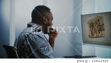 Airport Security Checkpoint: TSA Worker Controlling Scanning of Luggage on Computer Monitors 124812429