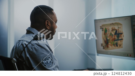 Airport Security Checkpoint: TSA Worker Controlling Scanning of Luggage on Computer Monitors Airport Security Checkpoint: TSA Worker Controlling Scanning of Luggage on Computer Monitors 124812430