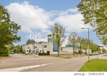 A vibrant city scene featuring modern architecture, clear skies, and lush greenery along the streets, showcasing a harmonious blend of nature and urban living. 124812453