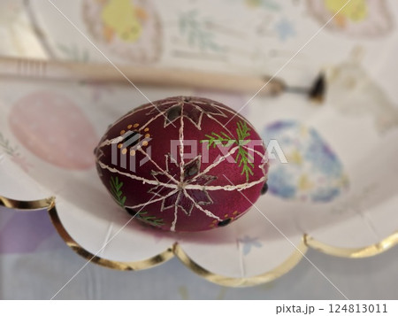 Traditional Ukrainian pysanka decorated with a beeswax technique on an Easter egg showcasing intricate folk patterns and vibrant colors 124813011