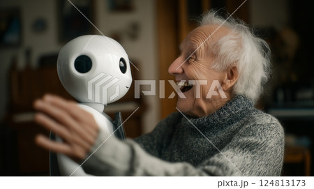 Elderly man joyfully interacting with a robot companion in a cozy indoor setting during the afternoon hours 124813173