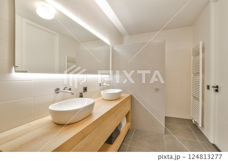 A sleek, modern bathroom featuring a minimalist design with clean lines, simple fixtures, and neutral colors, creating a serene atmosphere. A sleek, modern bathroom featuring a minimalist design with clean lines, simple fixtures, and neutral colors, creating a serene atmosphere. 124813277