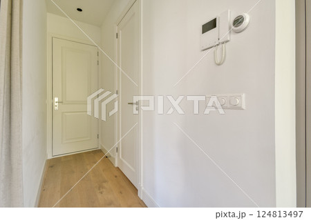 A sleek and modern hallway showcasing minimalistic design elements, clean lines, and a bright atmosphere emanating from natural light. A sleek and modern hallway showcasing minimalistic design elements, clean lines, and a bright atmosphere emanating from natural light. 124813497