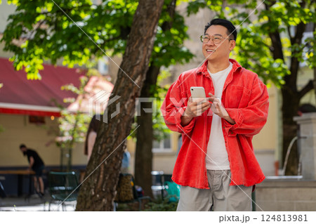 Asian middle-aged man using smartphone typing text messages in social media application online Asian middle-aged man using smartphone typing text messages in social media application online 124813981
