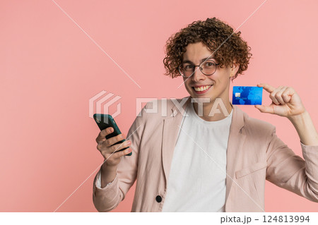 Man use credit bank card smartphone while transferring spending money, purchases online shopping Man use credit bank card smartphone while transferring spending money, purchases online shopping 124813994