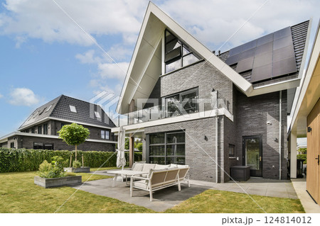 This contemporary home features sleek architecture, solar panels, and a beautifully landscaped garden, showcasing sustainable living in a serene environment. This contemporary home features sleek architecture, solar panels, and a beautifully landscaped garden, showcasing sustainable living in a serene environment. 124814012