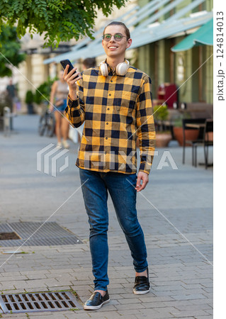 Man using smartphone typing texting social media messages looking for a way on map navigator app Man using smartphone typing texting social media messages looking for a way on map navigator app 124814013