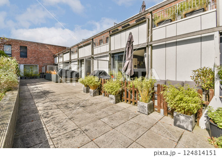 A beautifully designed outdoor residential area featuring contemporary architecture, lush greenery, and a peaceful atmosphere perfect for relaxation. 124814151