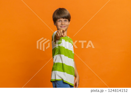 Happy excited child boy laughing out loud after hearing ridiculous anecdote, reaction on funny joke 124814152
