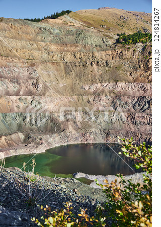 Old open mining pit with pond in mountain Old open mining pit with pond in mountain 124814267