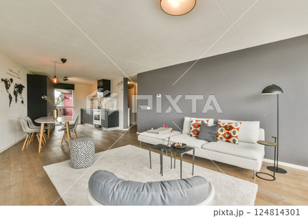 A stylish, modern living room featuring a minimalist design with elegant furniture, warm lighting, and a touch of global decor. Perfect for contemporary home aesthetics. A stylish, modern living room featuring a minimalist design with elegant furniture, warm lighting, and a touch of global decor. Perfect for contemporary home aesthetics. 124814301