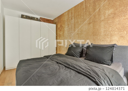 A contemporary minimalist bedroom featuring a neutral color palette, sleek furniture, and a cozy atmosphere that embodies comfort and style. A contemporary minimalist bedroom featuring a neutral color palette, sleek furniture, and a cozy atmosphere that embodies comfort and style. 124814371