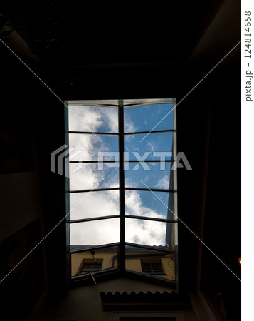 Open skylight window showing blue sky and clouds in prague 124814658