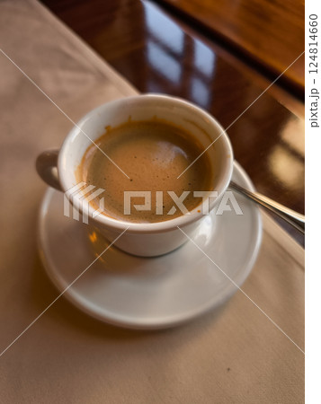 Enjoying a creamy coffee Lungo in a prague cafe, springtime treat Enjoying a creamy coffee Lungo in a prague cafe, springtime treat 124814660