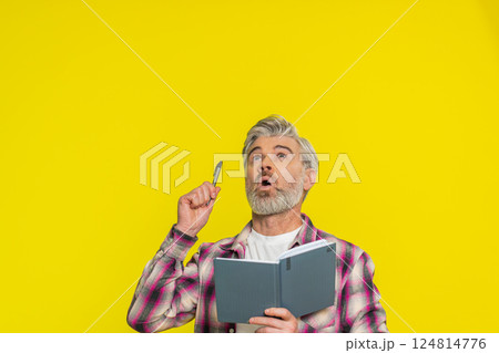 Mature man making notes writing thoughts with pen into notepad notebook diary to do list good idea Mature man making notes writing thoughts with pen into notepad notebook diary to do list good idea 124814776