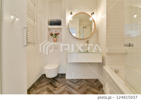 A stylish modern bathroom featuring a minimalist design with elegant fixtures and contrasting textures. Perfect for contemporary home aesthetics. 124815037