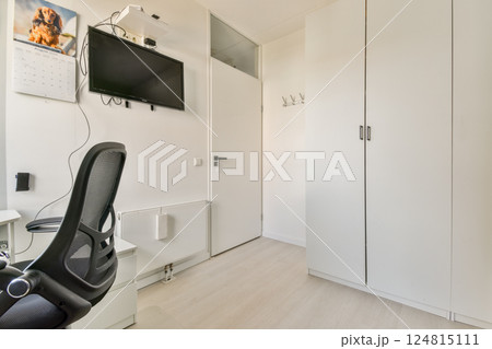 A clean and modern home office featuring a sleek desk, ergonomic chair, and minimal decor, promoting a focused work environment. A clean and modern home office featuring a sleek desk, ergonomic chair, and minimal decor, promoting a focused work environment. 124815111
