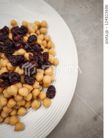 Chickpeas and dried cranberries are combined on a white plate, offering a nutritious and flavorful culinary experience healthy dinner for Galentines day Chickpeas and dried cranberries are combined on a white plate, offering a nutritious and flavorful culinary experience healthy dinner for Galentines day 124815686