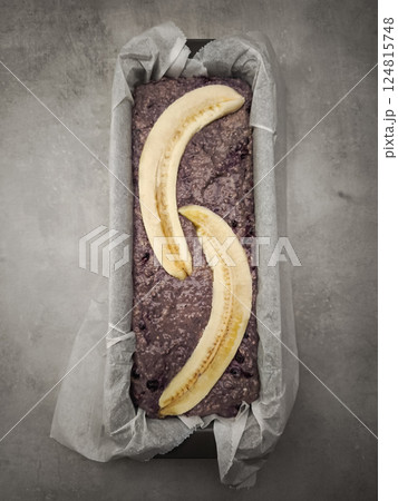 Banana slices decorating blueberry bread batter inside rustic loaf pan, preparing for golden brown baking for Mother's Day Valentines copy space Banana slices decorating blueberry bread batter inside rustic loaf pan, preparing for golden brown baking for Mother's Day Valentines copy space 124815748