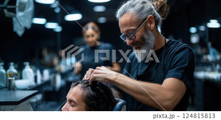 hairstylist with beard carefully styling client hair in modern salon 124815813