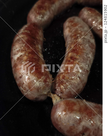 Close up of sausages sizzling on a black frying pan, cooking in chamonix, france, during november 124815902