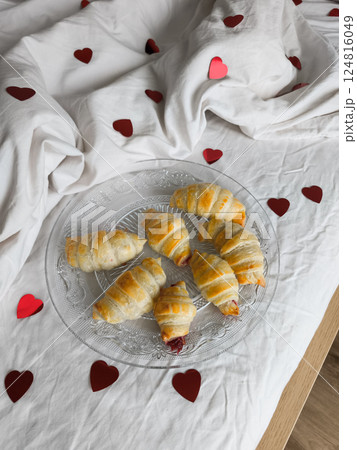 Romantic valentine's breakfast heart shaped decor and golden croissants, intimate morning ambiance for loving couples 124816049