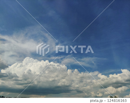 Expansive blue sky with dramatic clouds forming over Czechia, capturing the beauty of a summer day in july Expansive blue sky with dramatic clouds forming over Czechia, capturing the beauty of a summer day in july 124816163