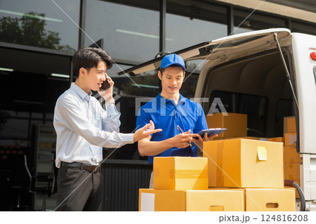 Asian man signs for parcel delivery, confirming shipment. Concept of e-commerce, logistics, and fast courier service for secure package handling. Asian man signs for parcel delivery, confirming shipment. Concept of e-commerce, logistics, and fast courier service for secure package handling. 124816208