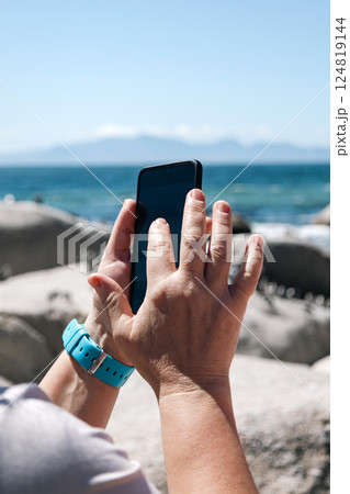 Female hands holding mobile phone and taking photos Female hands holding mobile phone and taking photos 124819144