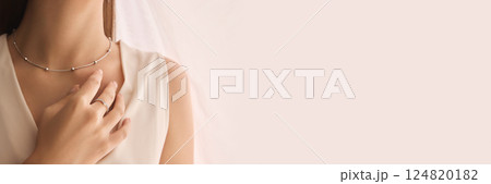 Cropped image of tender woman demonstrating elegant silver necklace and simple, minimalist ring 124820182