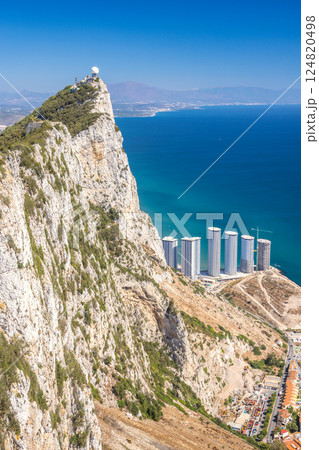 Gibraltar, British Overseas Territory and city on the Iberian Peninsula. Coastal clifftop view with modern buildings and ocean 124820498