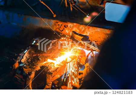 Close up hand heavy industrial worker is working on metal work factory process by Cutting sheet steel with gas cutting machine cutting thick steel in boilermakers workshop. 124821183