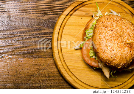 Bacon burger with beef patty on wooden table 124821258