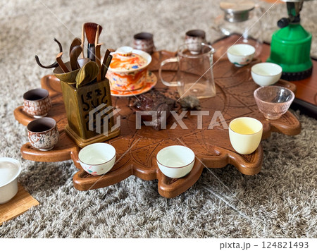 Vintage ceramic teapot and cups on linen with eucalyptus and moonstone jewelry. Tea ceremony and sensory aesthetics Vintage ceramic teapot and cups on linen with eucalyptus and moonstone jewelry. Tea ceremony and sensory aesthetics 124821493