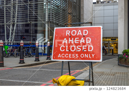 Road Ahead Closed sign in front of city construction zone with restricted access 124821684