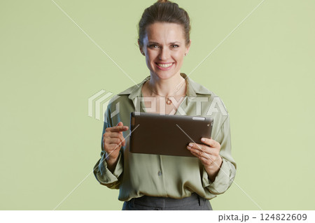 Smiling woman presents on tablet device Smiling woman presents on tablet device 124822609