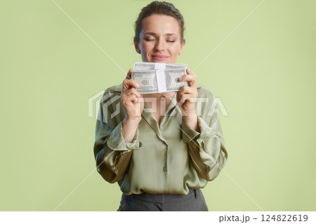 Woman embraces wealth: Content with stacks of cash Woman embraces wealth: Content with stacks of cash 124822619