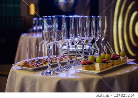 Appetizer Plate. An area for welcoming guests with food and empty champagne glasses Appetizer Plate. An area for welcoming guests with food and empty champagne glasses 124823214