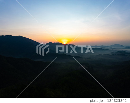 Beautiful sunset or sunrise sky nature landscape in Thailand,Amazing landscape colorful clouds over mountains in summer season background,Wide angle view drone shot 124823842